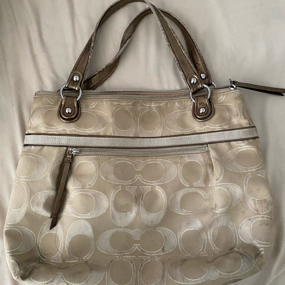 Pre-owned COACH bag with noticeable wear and tear upon close inspection.